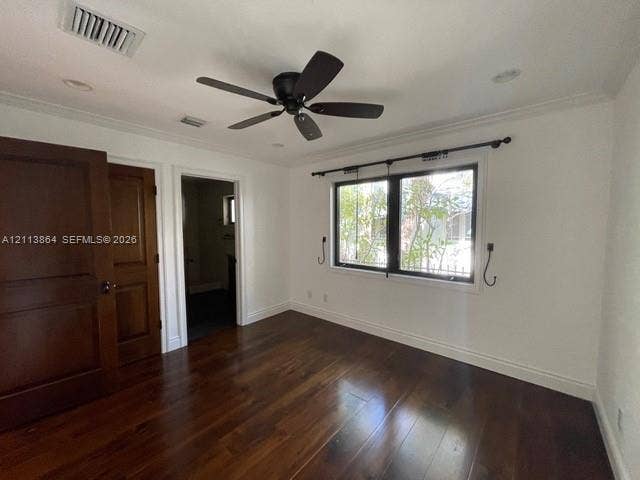 721 Tibidabo Avenue, #0, Coral Gables, Coral Gables, FL 33143 Room featuring wood-finish flooring, dark-toned wood interior doors, ceiling fan, and multi-pane window with dark-toned framing