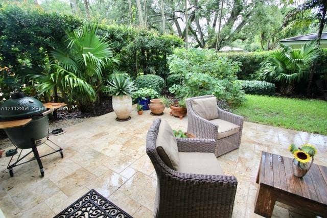 721 Tibidabo Avenue, #0, Coral Gables, Coral Gables, FL 33143 Stone paver patio featuring integrated landscaping with mature palm trees and manicured shrubbery