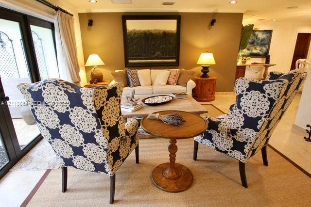 721 Tibidabo Avenue, #0, Coral Gables, Coral Gables, FL 33143 Light-filled interior space featuring neutral wall tones, multi-panel glass doors with black frames, and stone-finish flooring
