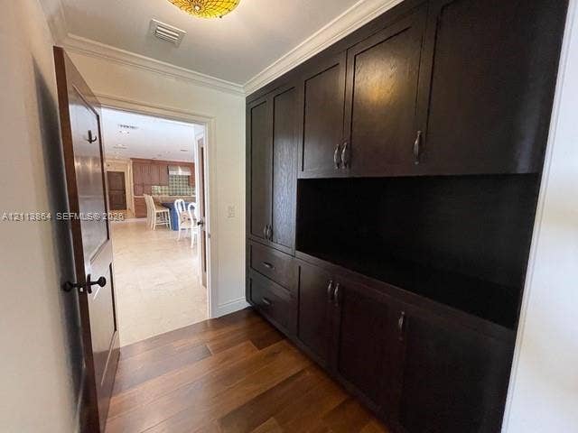 721 Tibidabo Avenue, #0, Coral Gables, Coral Gables, FL 33143 Dark wood built-in cabinetry featuring shaker-style doors, drawers, and open shelving, complemented by wood-finish flooring and crown molding