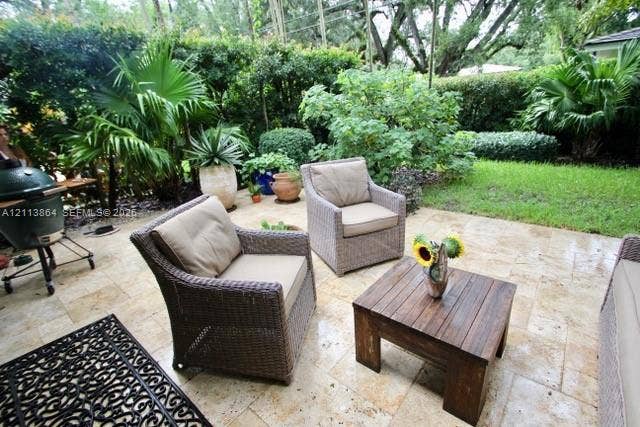 721 Tibidabo Avenue, #0, Coral Gables, Coral Gables, FL 33143 Stone paver patio featuring established perimeter landscaping, mature trees, and a grass lawn