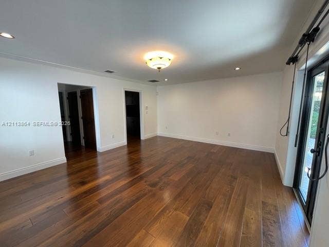 721 Tibidabo Avenue, #0, Coral Gables, Coral Gables, FL 33143 Wide-plank wood-finish flooring, recessed ceiling lighting, decorative flush-mount light fixture, and black-framed glass sliding doors