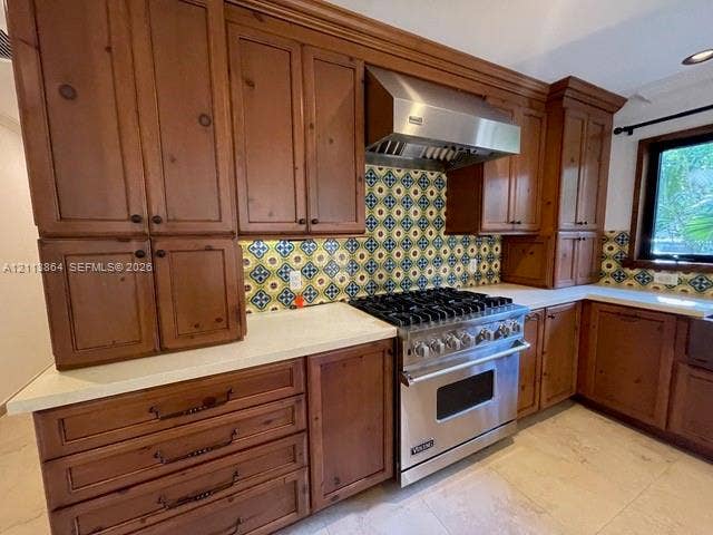 721 Tibidabo Avenue, #0, Coral Gables, Coral Gables, FL 33143 Custom wood cabinetry, stainless steel professional-grade gas range, stainless steel vent hood, patterned tile backsplash, and light-toned solid surface countertops