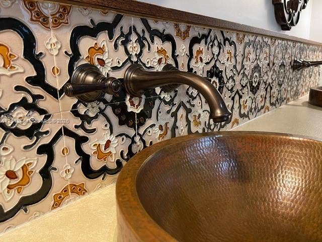 721 Tibidabo Avenue, #0, Coral Gables, Coral Gables, FL 33143 Hammered copper vessel sink paired with a wall-mounted bronze faucet and intricate patterned tile backsplash