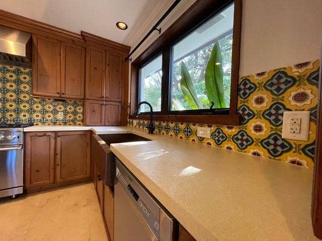 721 Tibidabo Avenue, #0, Coral Gables, Coral Gables, FL 33143 Kitchen featuring custom wood cabinetry, patterned tile backsplash, solid-surface countertops, farmhouse sink with matte black hardware, and stainless steel dishwasher