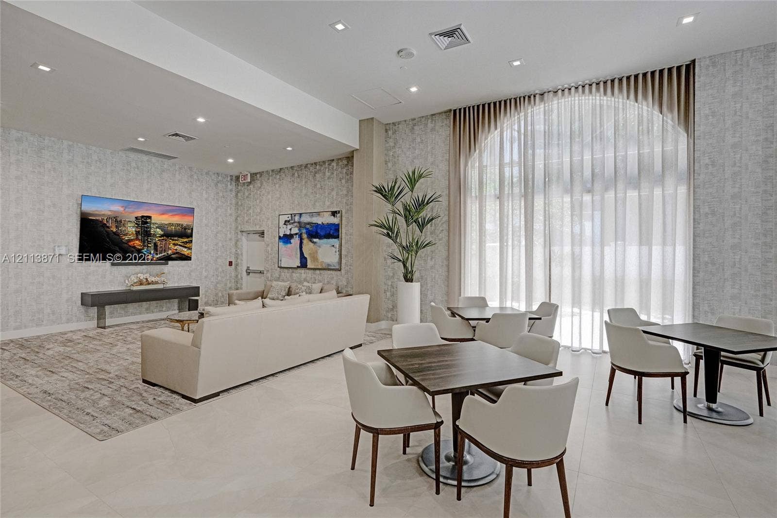 3640 Yacht Club Drive, #1208, Aventura, FL 33180 Common space featuring high ceilings, floor-to-ceiling arched windows, patterned wall coverings, recessed lighting, and large-format tile flooring
