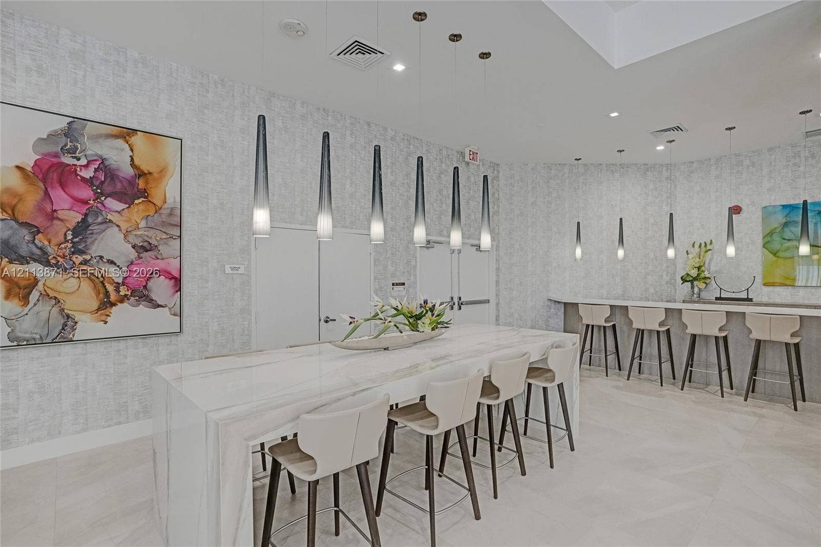 3640 Yacht Club Drive, #1208, Aventura, FL 33180 Waterfall-edge island with stone-finish countertop, minimalist pendant lighting, tiled flooring, and textured wall covering