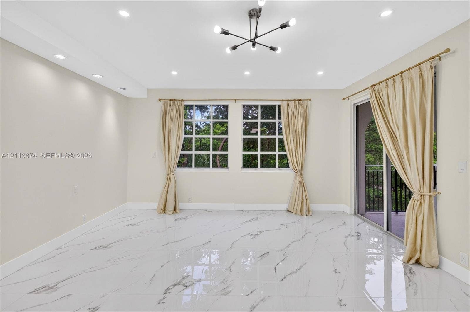 3900 Island Boulevard, #B408, Aventura, Aventura, FL 33160 Polished stone-finish flooring, modern sputnik-style chandelier, recessed lighting, multi-pane windows, and sliding glass door