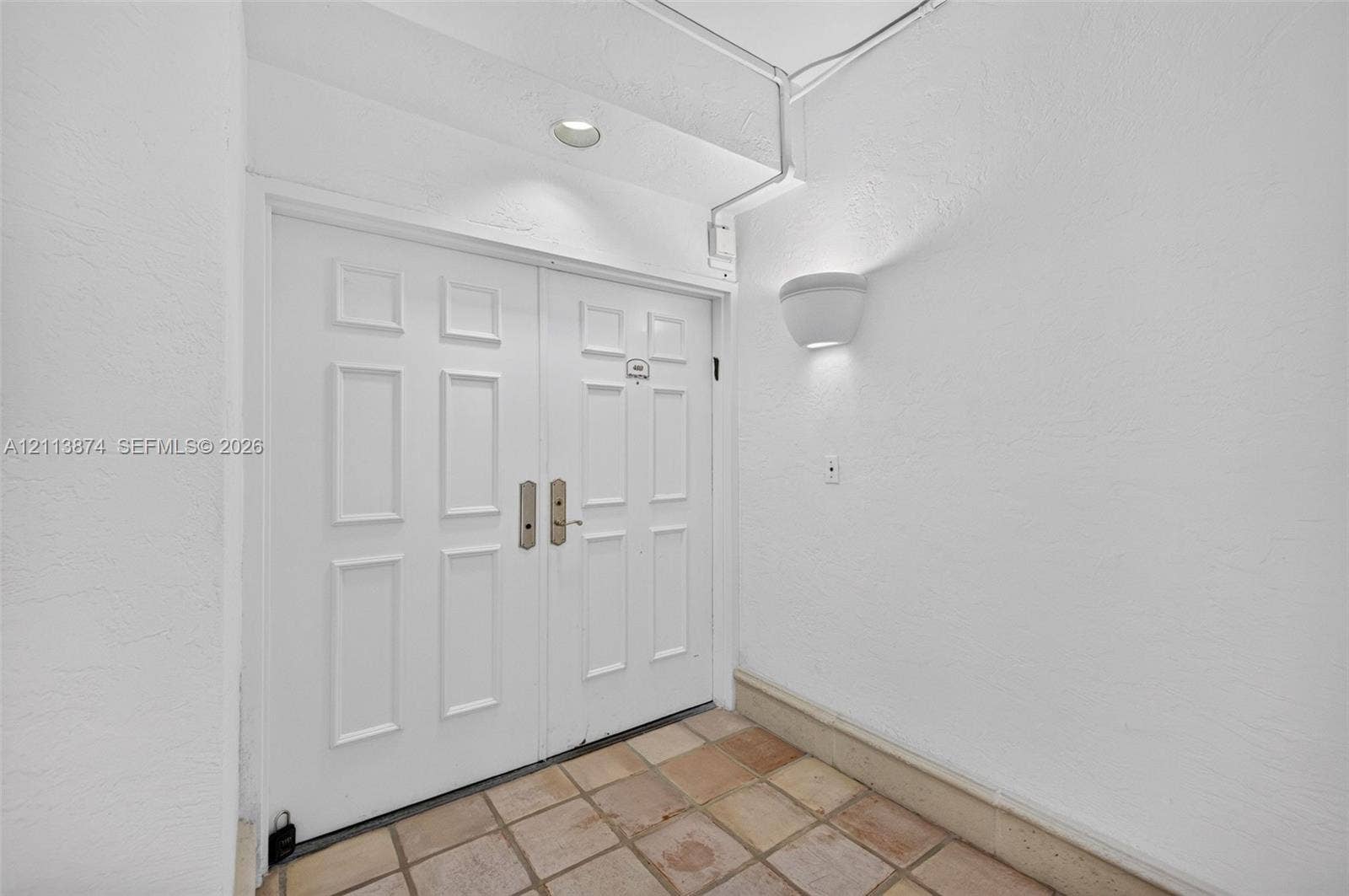 3900 Island Boulevard, #B408, Aventura, Aventura, FL 33160 Double entry doors featuring a six-panel design, white-finished hardware, recessed ceiling lighting, and tiled flooring