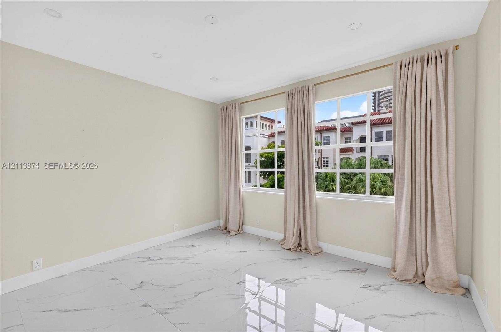 3900 Island Boulevard, #B408, Aventura, Aventura, FL 33160 Large-format tile flooring with a neutral-toned veined pattern, recessed lighting, and expansive multi-pane windows