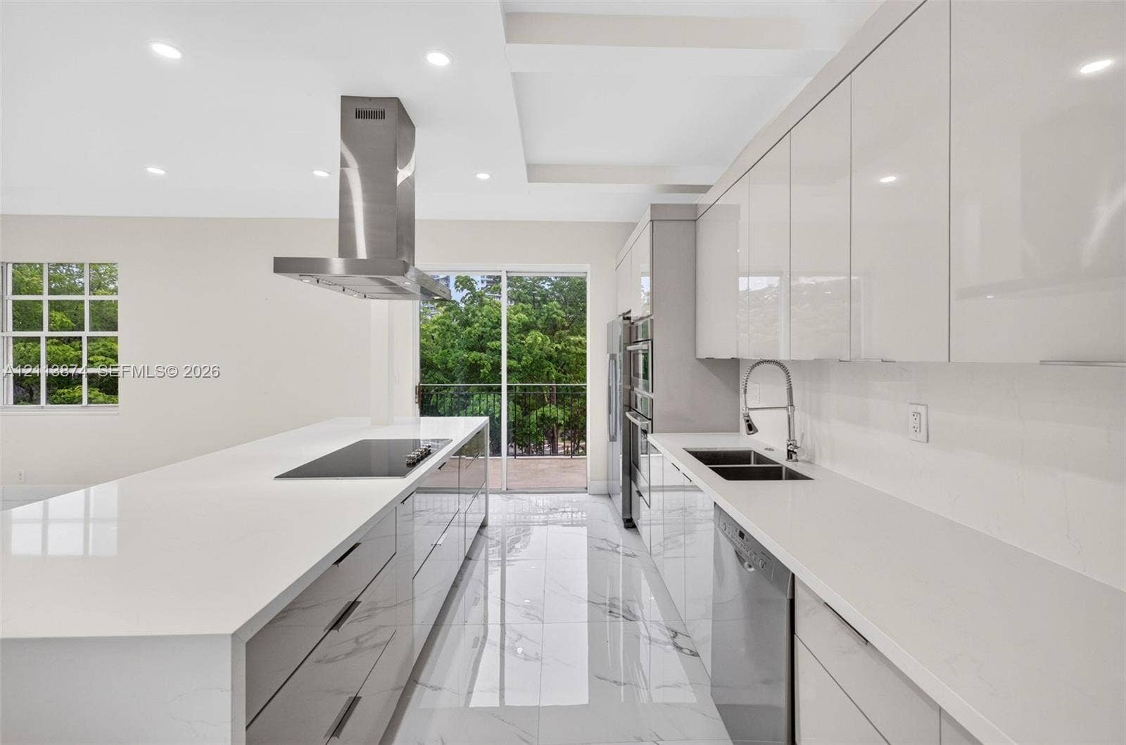 3900 Island Boulevard, #B408, Aventura, Aventura, FL 33160 Kitchen featuring gloss-finish cabinetry, waterfall-edge quartz countertops, stainless steel appliances, stainless steel range hood, and porcelain tile flooring