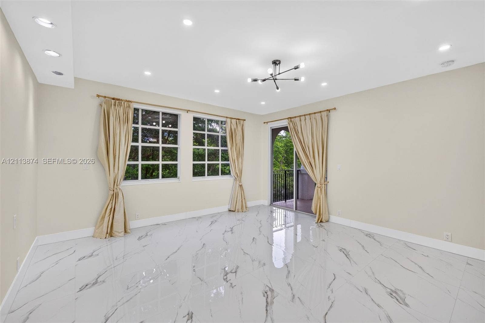 3900 Island Boulevard, #B408, Aventura, Aventura, FL 33160 Polished stone-finish flooring, recessed lighting, multi-arm chandelier, grid-pattern windows, and sliding glass doors with balcony access