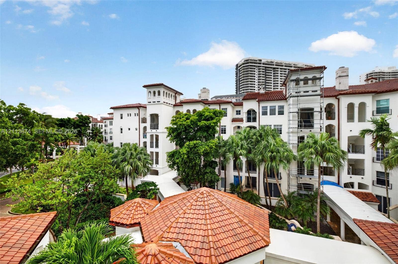 3900 Island Boulevard, #B408, Aventura, Aventura, FL 33160 Stucco exterior featuring mission-style clay tile roofs, tower accents, arched window detailing, and covered walkways
