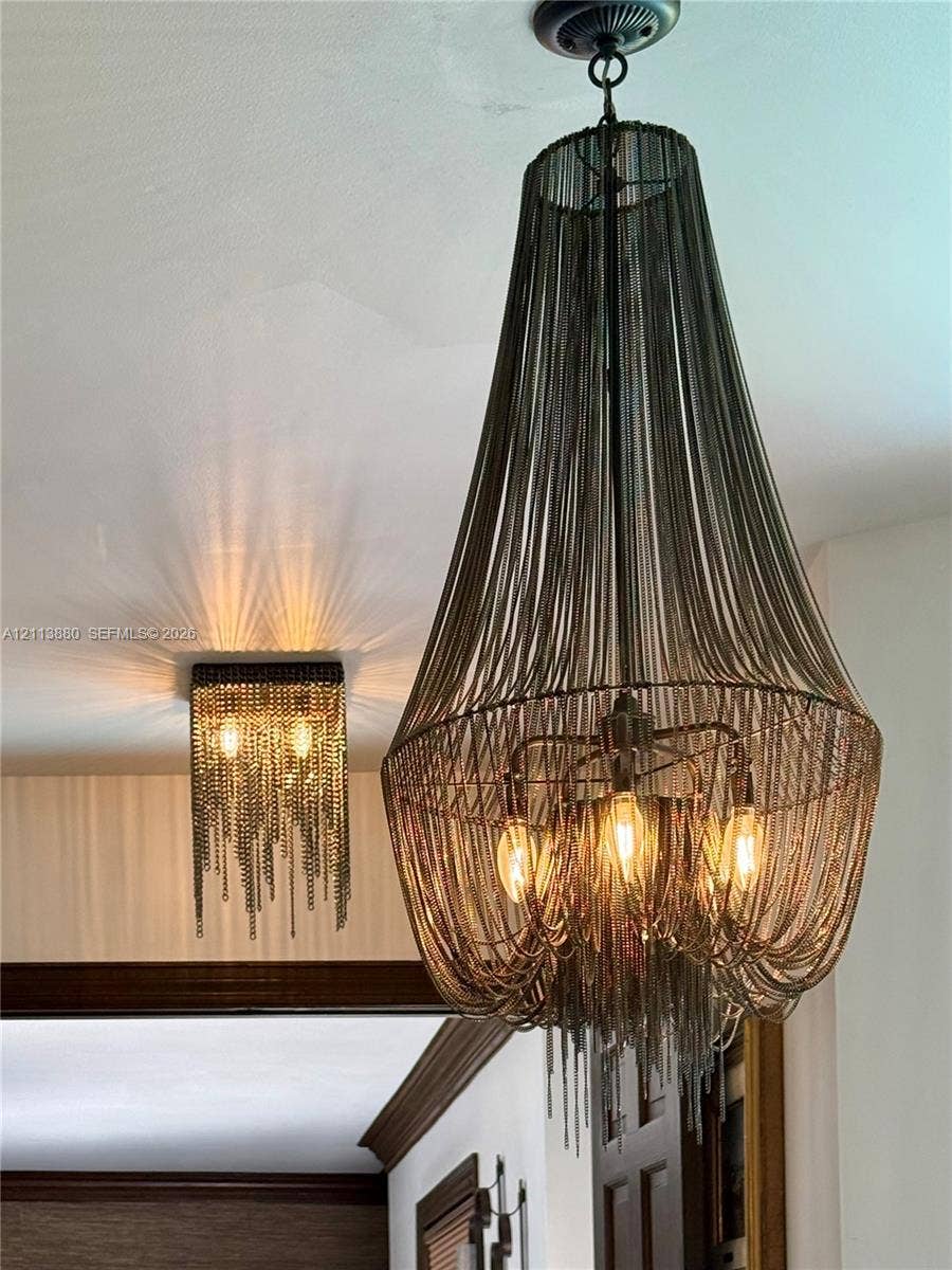 900 Coco Plum Way, Plantation, FL 33324 Tiered chandelier featuring draped metallic chain-link construction and a square flush-mount ceiling fixture with matching chain detailing and exposed bulbs