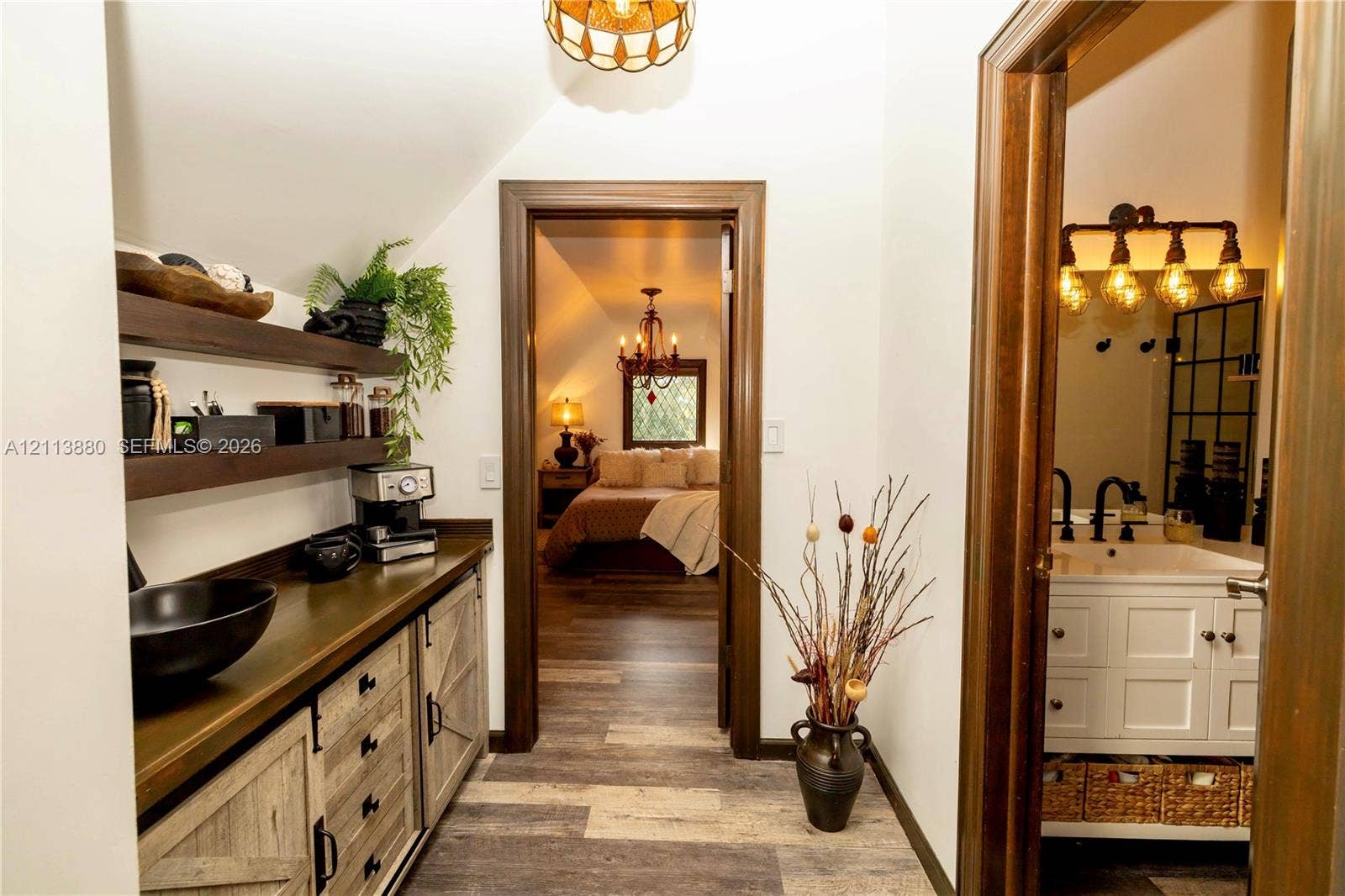 900 Coco Plum Way, Plantation, FL 33324 Built-in cabinetry featuring wood-finish lower cabinets with barn-style doors and dark-toned open shelving