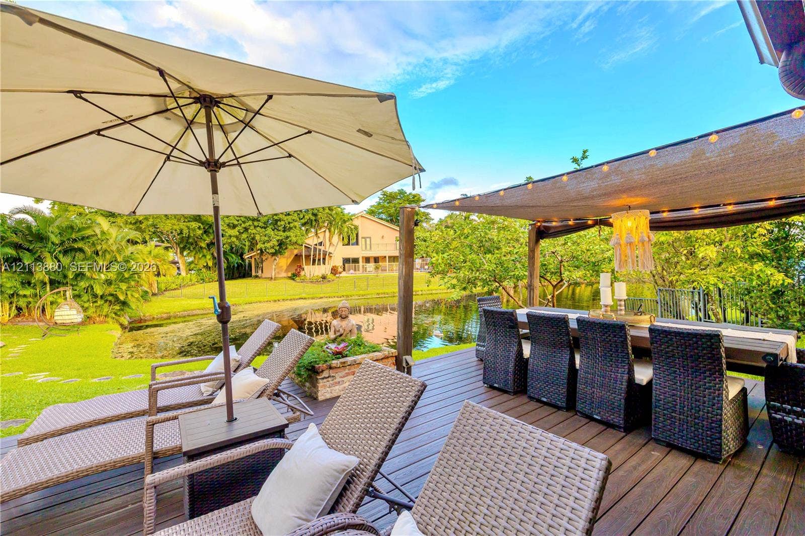900 Coco Plum Way, Plantation, FL 33324 Wood-plank deck featuring a fabric shade canopy and water frontage