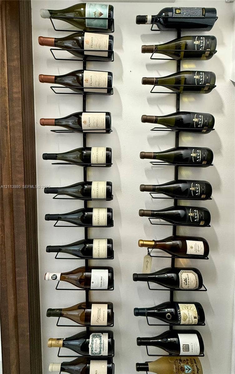 900 Coco Plum Way, Plantation, FL 33324 Wall-mounted metal wine storage racks featuring vertical alignment and individual bottle support
