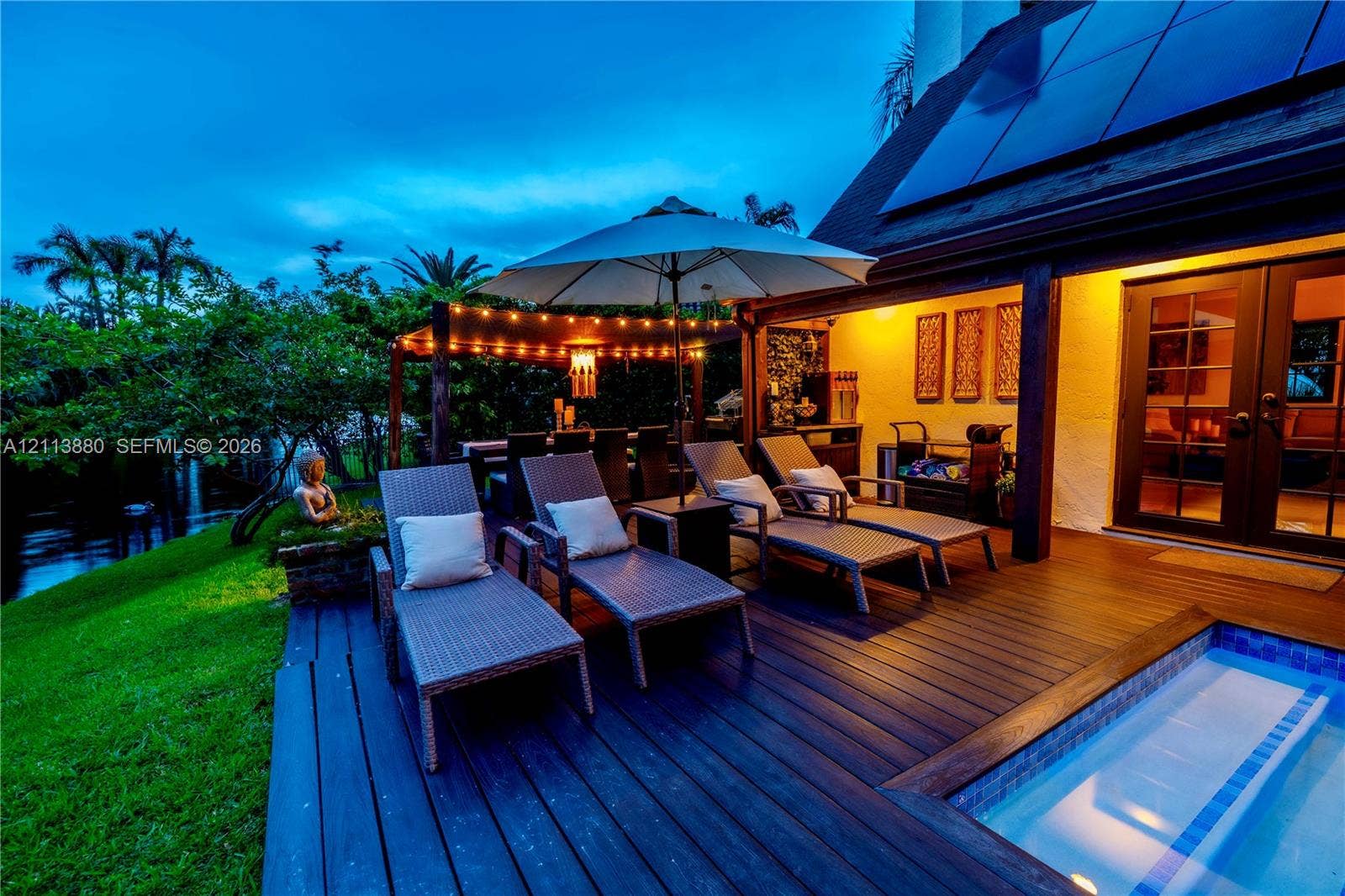 900 Coco Plum Way, Plantation, FL 33324 Wood-finish deck featuring an integrated pool, covered pergola structure, and glass-paned double doors