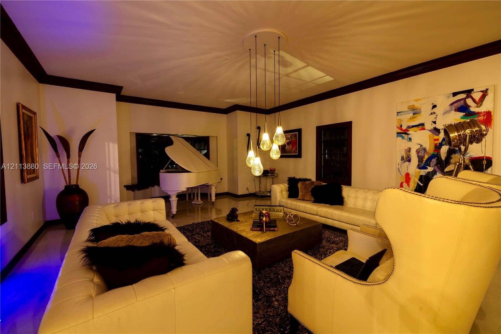 900 Coco Plum Way, Plantation, FL 33324 Living space featuring high ceilings, dark crown molding, polished flooring, and a multi-pendant glass light fixture