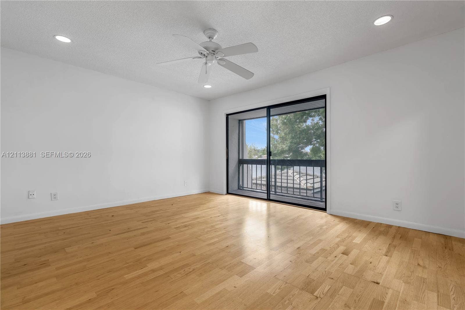 3886 Meadow Lane, #250, Hollywood, FL 33021 Wood-finish flooring, recessed lighting, white walls, ceiling fan, and sliding glass door with balcony access