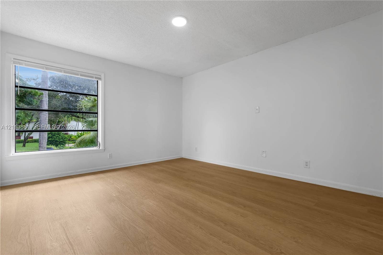 3886 Meadow Lane, #250, Hollywood, FL 33021 Bright room featuring wood-finish flooring, a multi-pane horizontal window, and recessed ceiling lighting