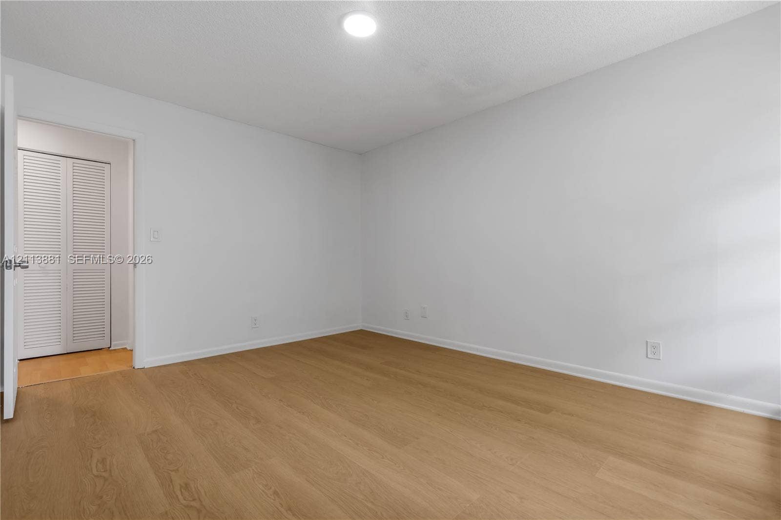 3886 Meadow Lane, #250, Hollywood, FL 33021 Wood-finish flooring, neutral walls, recessed ceiling lighting, and a closet with white louvered doors
