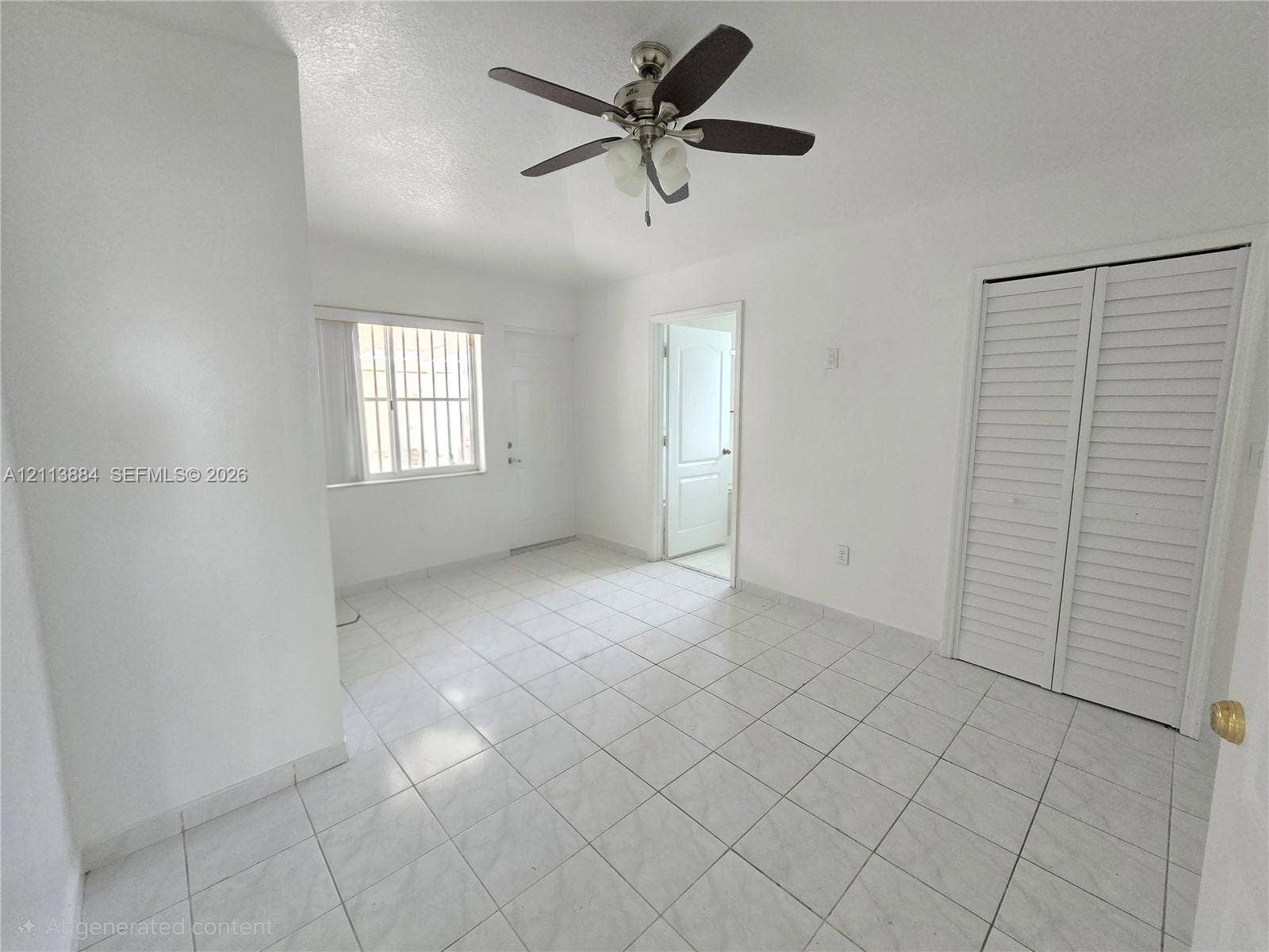 7456 W 34th Court, Hialeah, FL 33018 Interior room featuring tile flooring, ceiling fan with light fixture, louvered closet doors, and multi-pane window