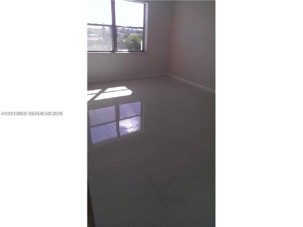 401 Golden Isles Drive, #509, Hallandale Beach, FL 33009 Polished tile flooring and large window providing natural light