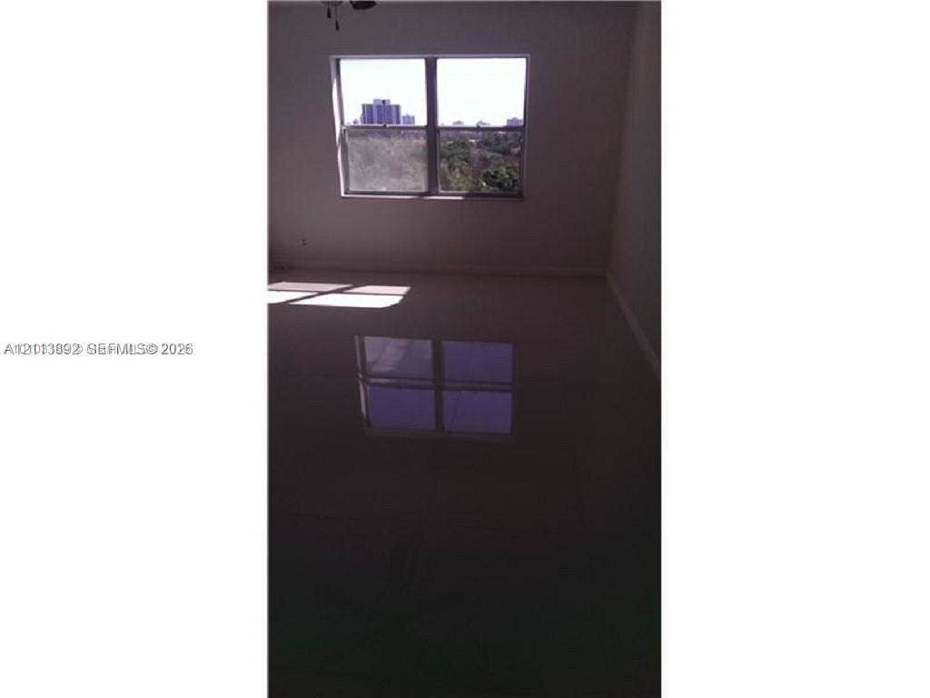 401 Golden Isles Drive, #509, Hallandale Beach, FL 33009 Interior space featuring large-format tile flooring and a double-pane window with a frame-integrated muntin