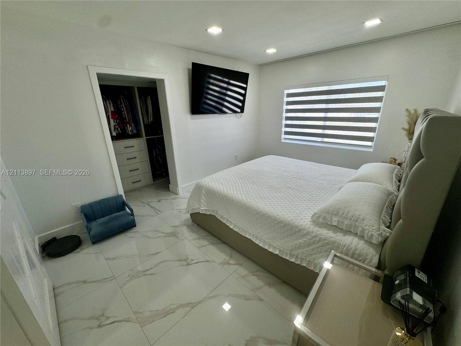 520 E 58th Street, Hialeah, FL 33013 Large-format tile flooring, recessed ceiling lighting, and a walk-in closet featuring built-in shelving and drawer storage