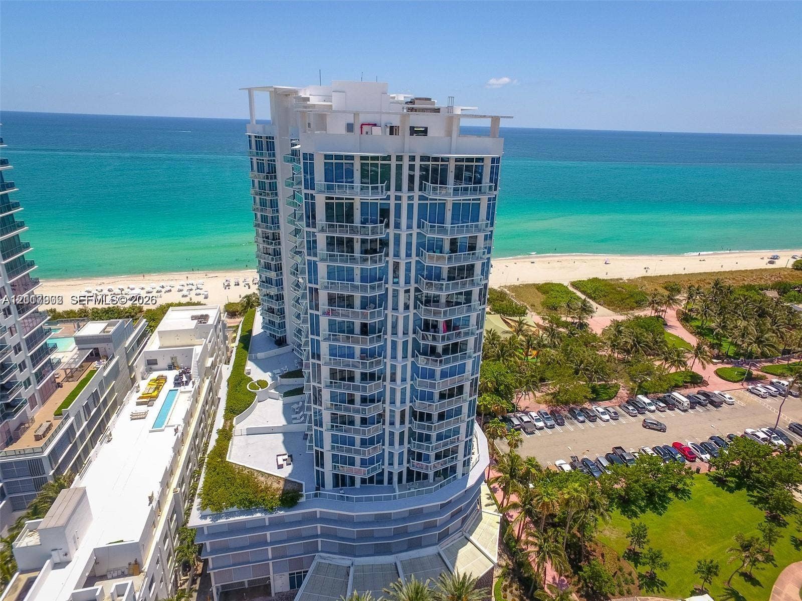 6515 Collins Avenue, #1609, Miami Beach, Miami Beach, FL 33141 High-rise residential tower featuring floor-to-ceiling glass windows, wraparound balconies, and direct oceanfront positioning