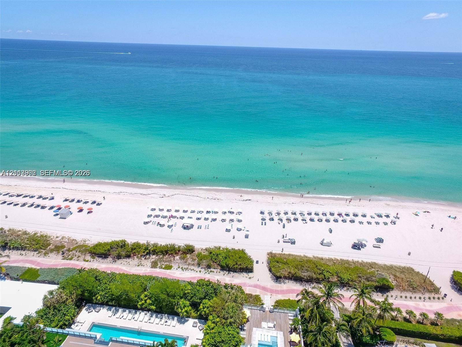 6515 Collins Avenue, #1609, Miami Beach, Miami Beach, FL 33141 Direct oceanfront access with expansive white sand beach, paved coastal pedestrian pathway, and landscaped grounds featuring a rectangular swimming pool with integrated sun deck