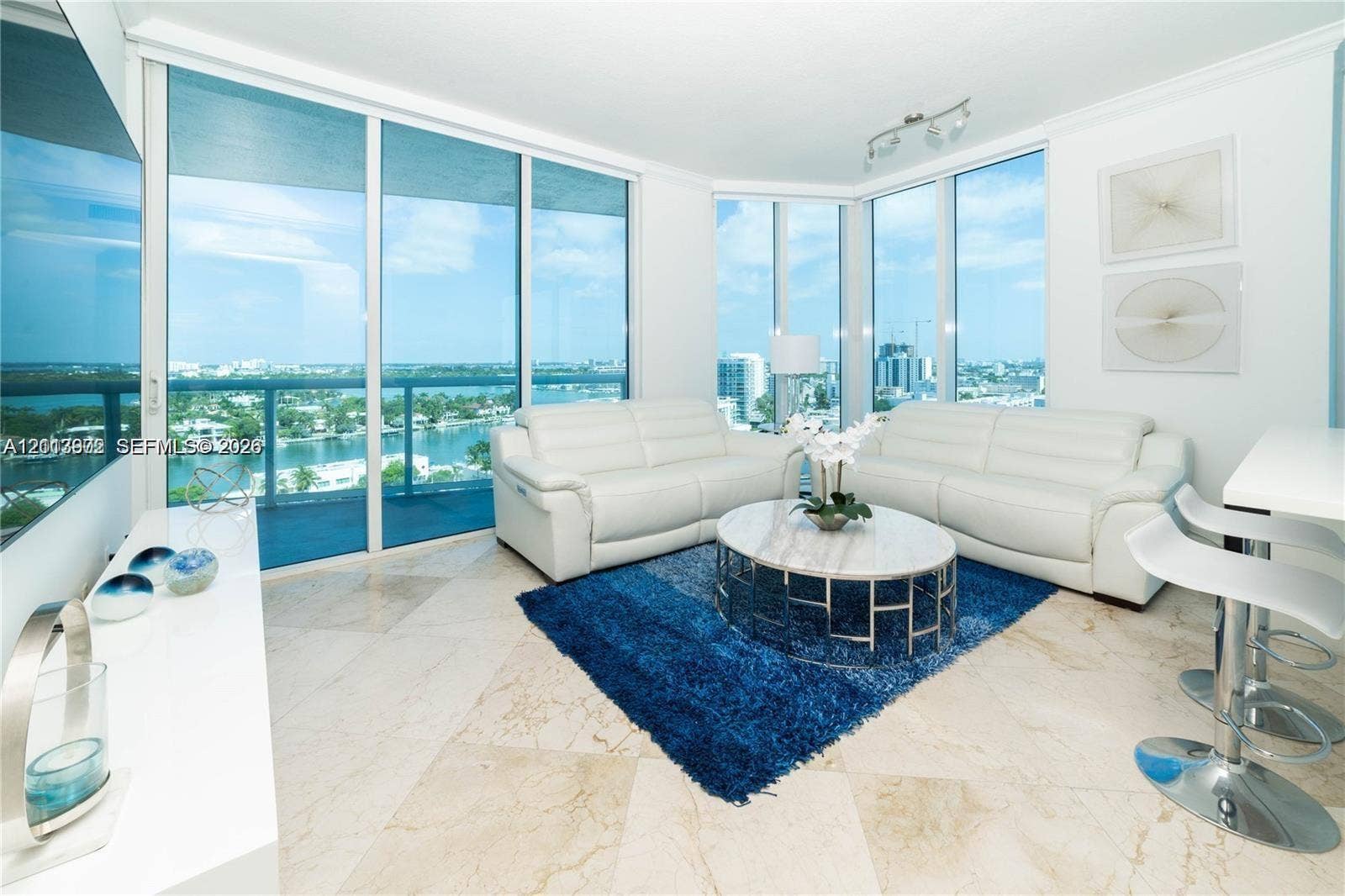 6515 Collins Avenue, #1609, Miami Beach, Miami Beach, FL 33141 Floor-to-ceiling glass walls, wrap-around balcony access, stone tile flooring, and multi-directional panoramic water scenery