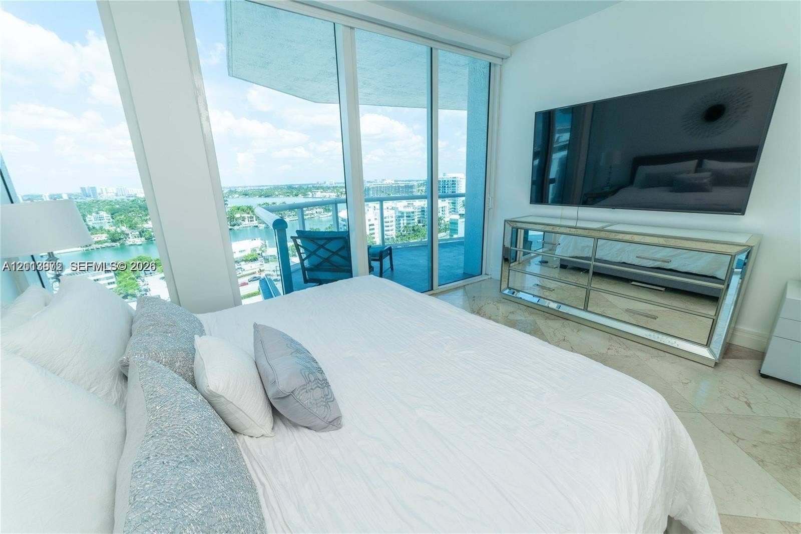6515 Collins Avenue, #1609, Miami Beach, Miami Beach, FL 33141 Floor-to-ceiling glass sliding doors, private balcony, tile flooring, and neutral wall finishes