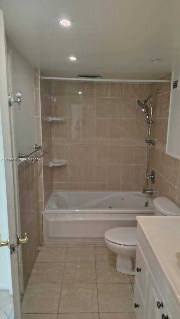 1301 Miami Gardens Drive, #1521 W, Miami, Miami, FL 33179 Bathroom featuring a combination bathtub and shower with beige wall tiling, recessed lighting, ceramic floor tile, and a white vanity