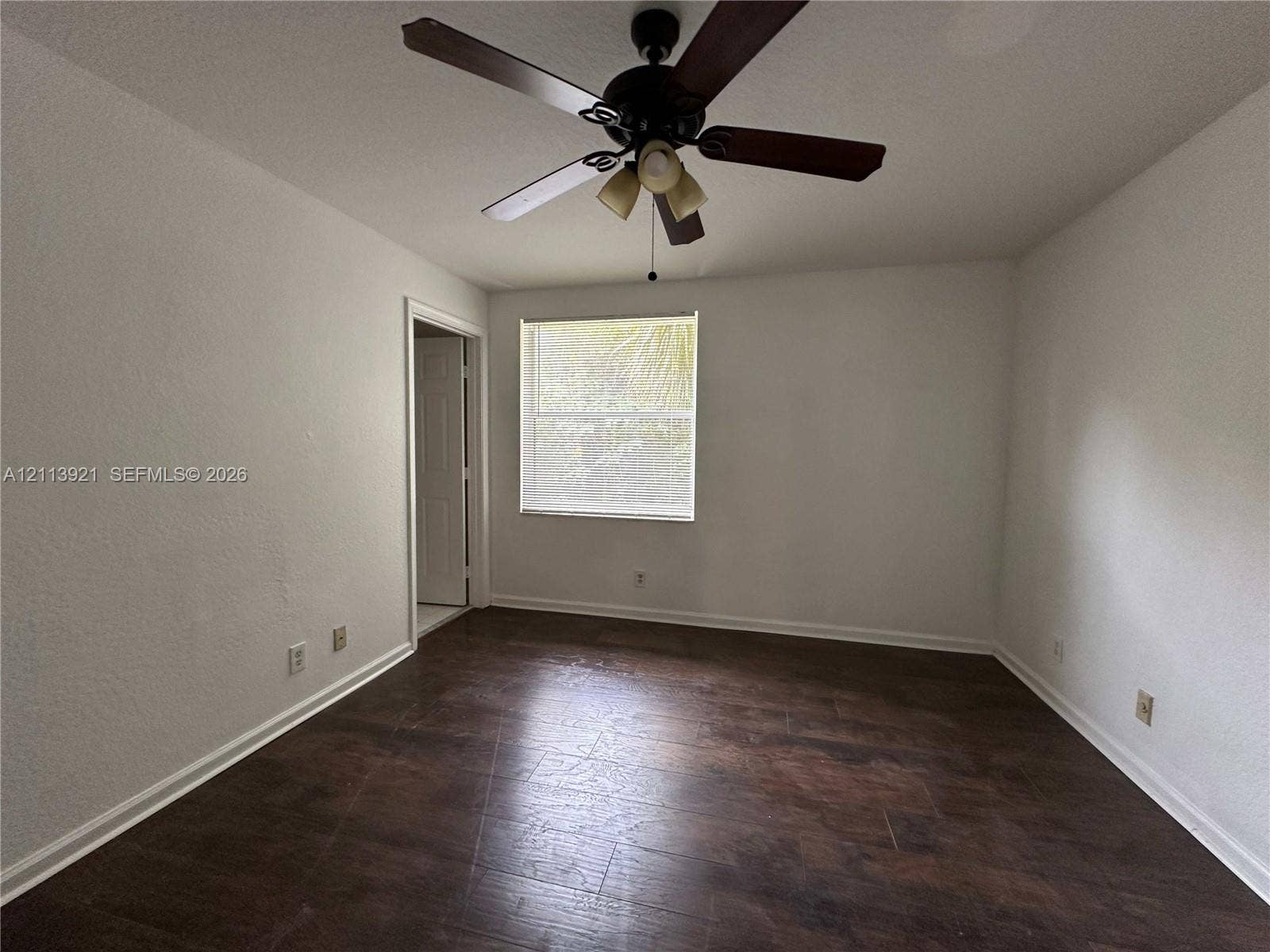 824 Summit Lake Drive, West Palm Beach, West Palm Beach, FL 33406 Room featuring wood-finish flooring, a central ceiling fan with integrated lighting, and a single-pane window