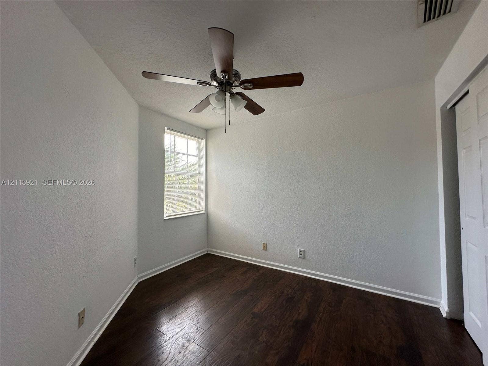 824 Summit Lake Drive, West Palm Beach, West Palm Beach, FL 33406 Wood-finish flooring, multi-pane window, ceiling fan with integrated light fixture, and paneled closet door
