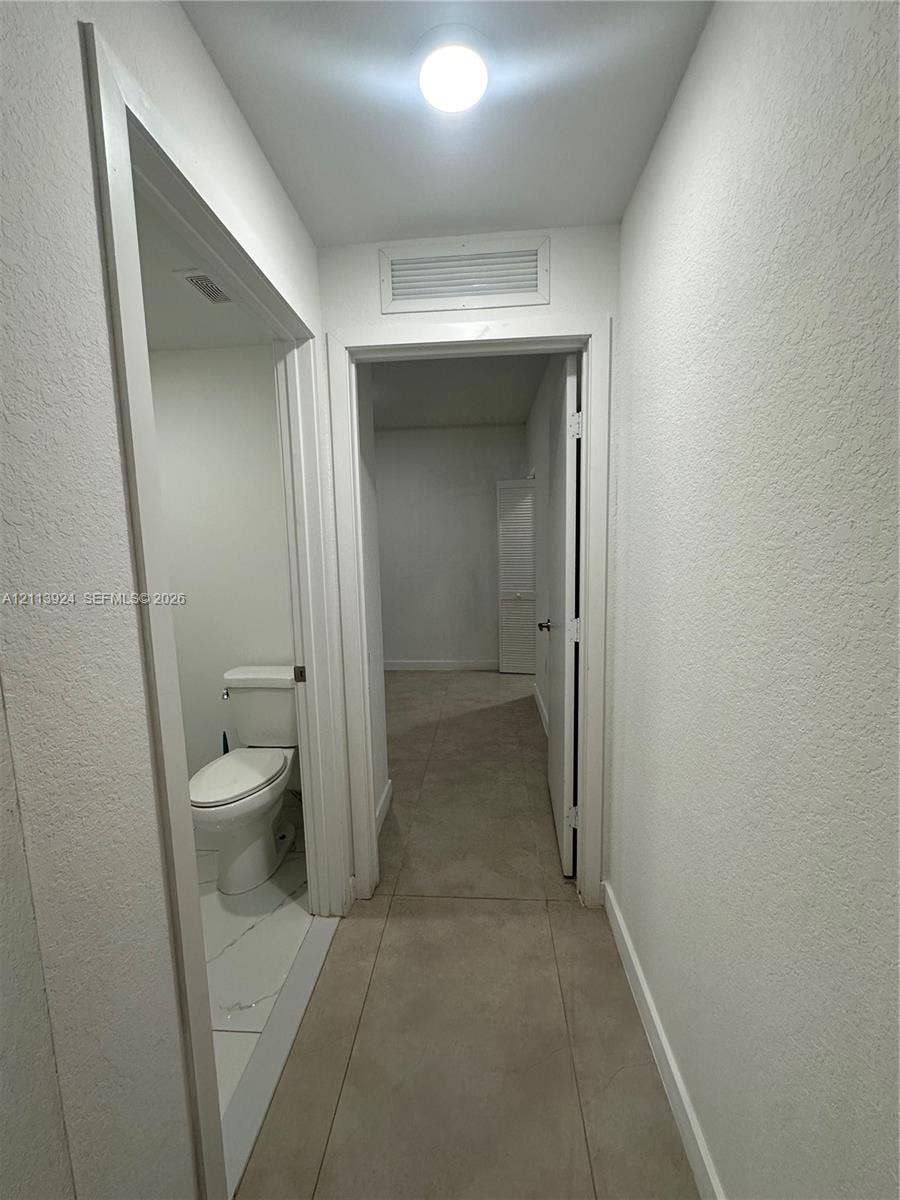 14569 SW 261st Terrace, #14569, Homestead, Homestead, FL 33032 Neutral-toned tile flooring, flush-mount ceiling lighting, and a white two-piece toilet