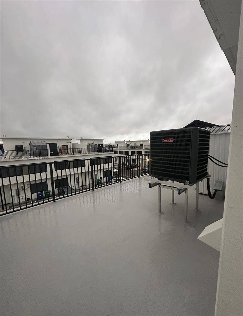 14569 SW 261st Terrace, #14569, Homestead, Homestead, FL 33032 Rooftop terrace featuring a smooth-finish deck, black metal railing, and a mounted HVAC unit