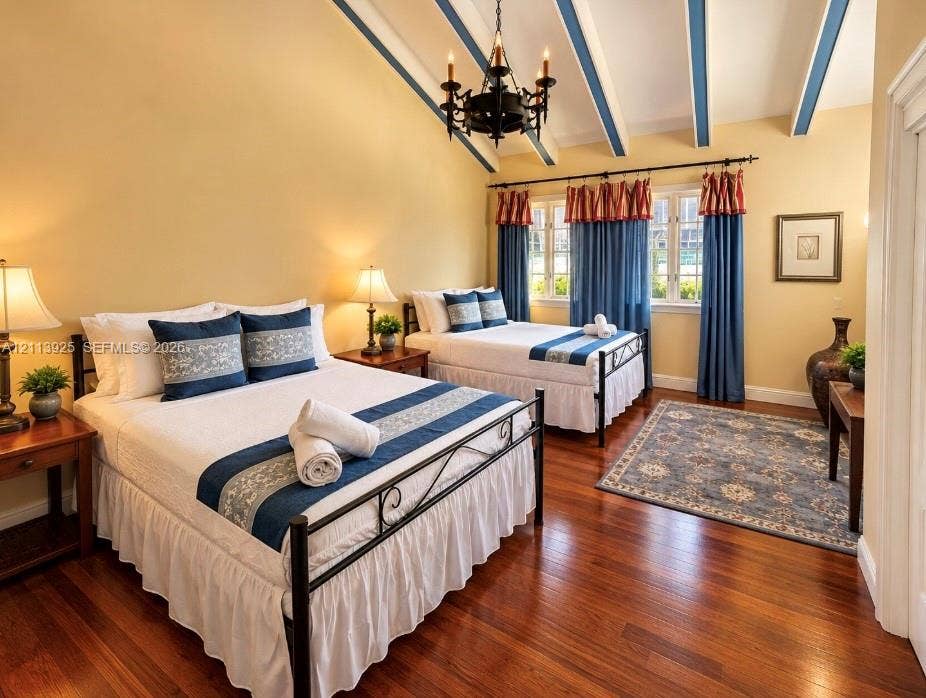 1055 Hollywood Boulevard, Hollywood, Hollywood, FL 33019 Vaulted ceiling with exposed decorative beams, iron chandelier, and polished wood-finish flooring