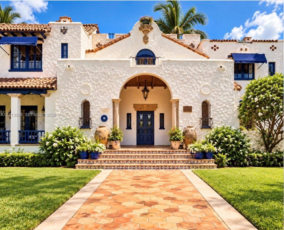 1055 Hollywood Boulevard, Hollywood, Hollywood, FL 33019 Spanish Revival exterior featuring a textured stucco facade, red tile roof, arched entryway, ornate tiled stairs, and a hexagonal paver walkway