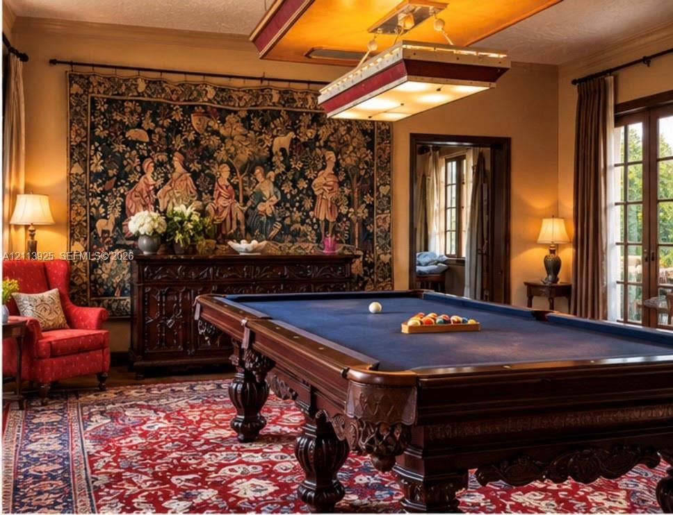 1055 Hollywood Boulevard, Hollywood, Hollywood, FL 33019 Custom rectangular billiard light fixture with a metallic frame, wood-trimmed French doors with glass panes, and crown molding