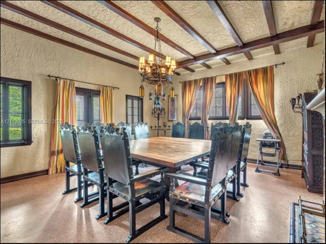 1055 Hollywood Boulevard, Hollywood, Hollywood, FL 33019 Exposed dark wood ceiling beams, textured plaster walls, wrought-iron multi-tier chandelier, and tile flooring