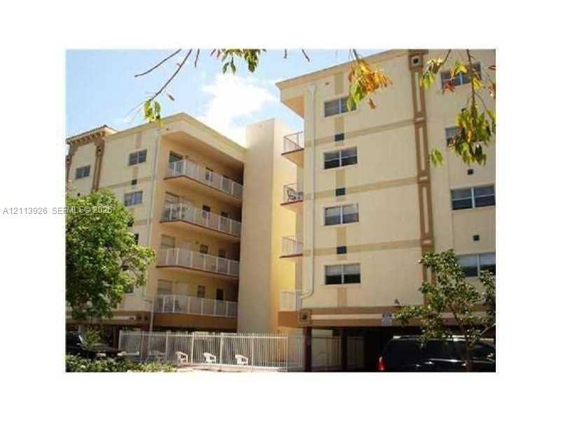 2008 Jackson Street, #D3, Hollywood, FL 33020 Multi-story stucco exterior featuring stacked private balconies with metal railings and under-building parking