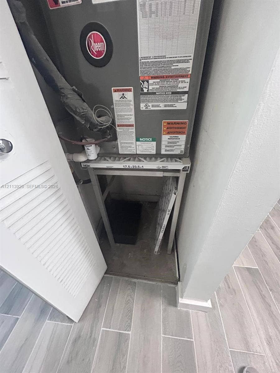 2008 Jackson Street, #D3, Hollywood, FL 33020 Heating and cooling unit housed in a dedicated closet with louvered door access and wood-finish tile flooring