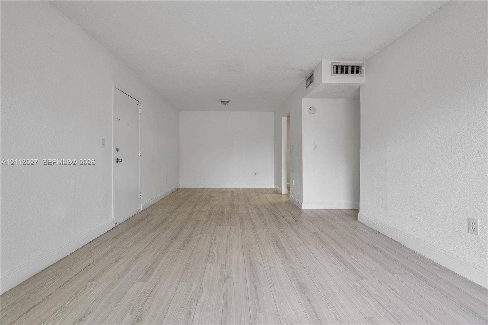 4900 NW 79th Avenue, #202, Doral, Doral, FL 33166 Open-concept interior featuring light-toned wood-finish flooring and neutral wall paint