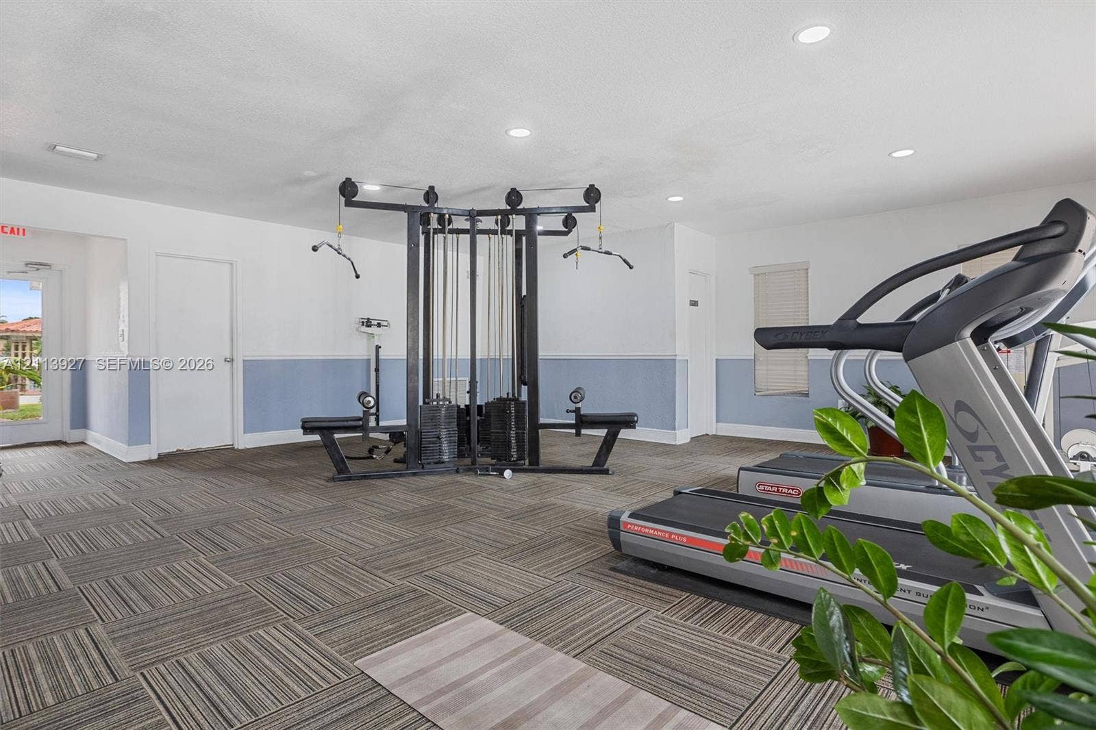 4900 NW 79th Avenue, #202, Doral, Doral, FL 33166 Fitness area featuring patterned tile flooring, recessed lighting, and wall-mounted blinds