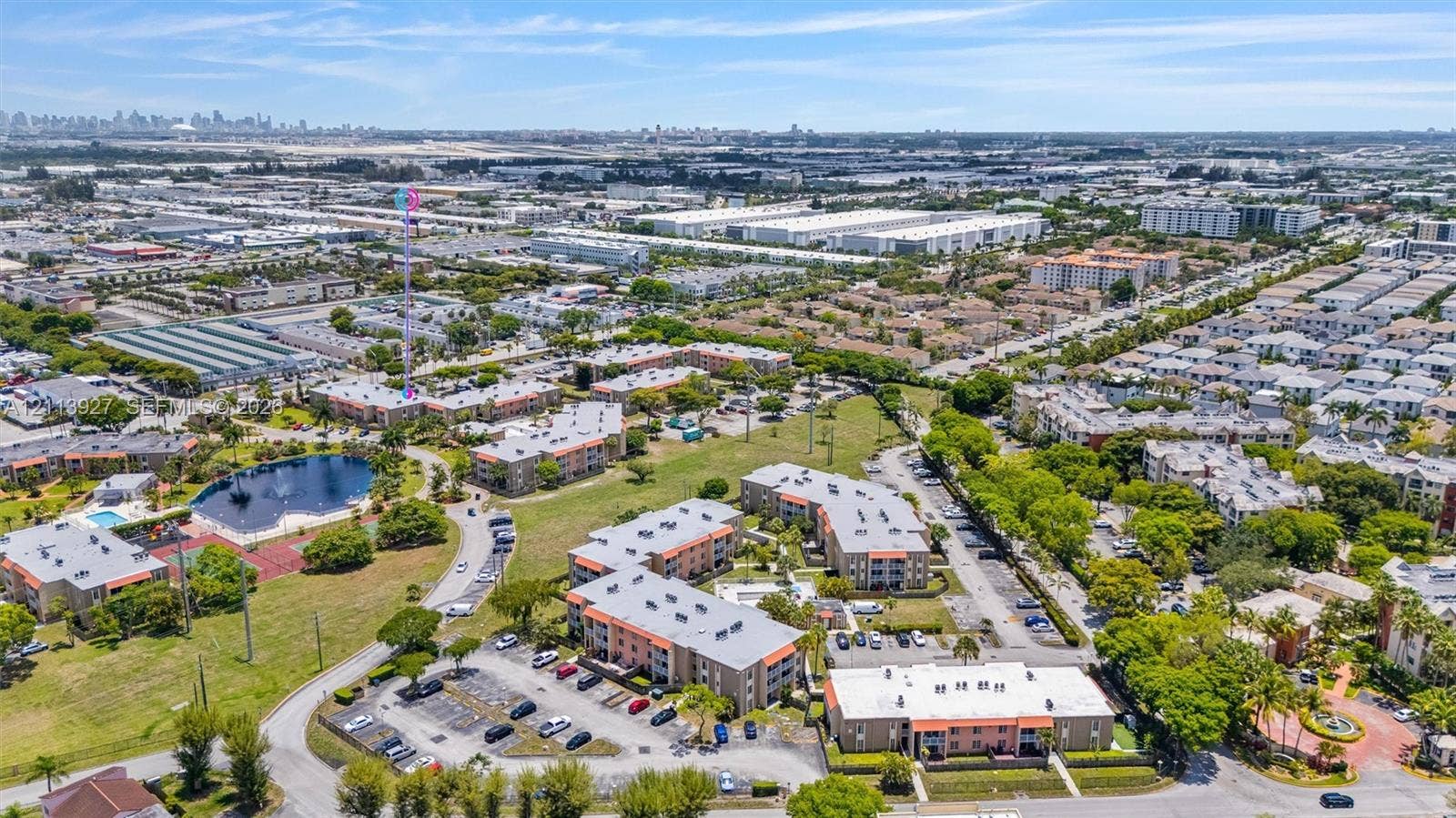 4900 NW 79th Avenue, #202, Doral, Doral, FL 33166 Aerial perspective of a multi-building residential complex featuring surface parking areas, landscaped grounds, and a central water feature