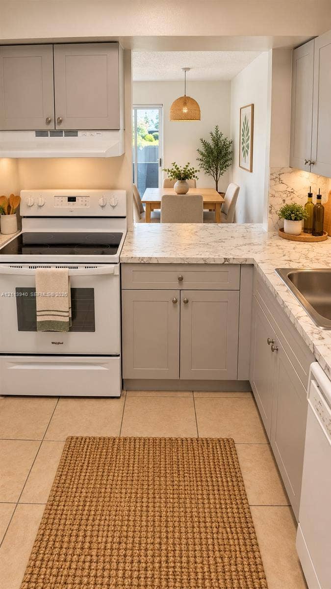 11150 SW 196th Street, #D211, Cutler Bay, Cutler Bay, FL 33157 Kitchen featuring grey shaker-style cabinetry, white appliances, stone-patterned countertops, and tile flooring