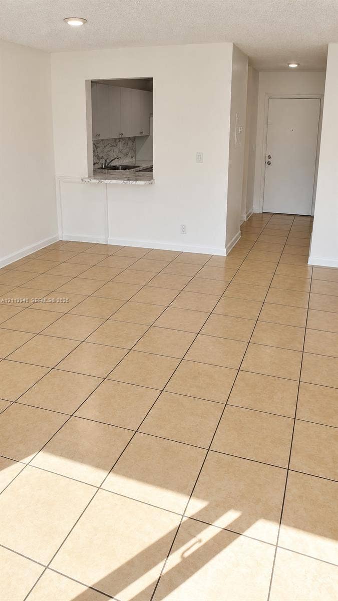 11150 SW 196th Street, #D211, Cutler Bay, Cutler Bay, FL 33157 Ceramic tile flooring, pass-through opening, stone-finish countertop, recessed lighting, and solid-core entry door